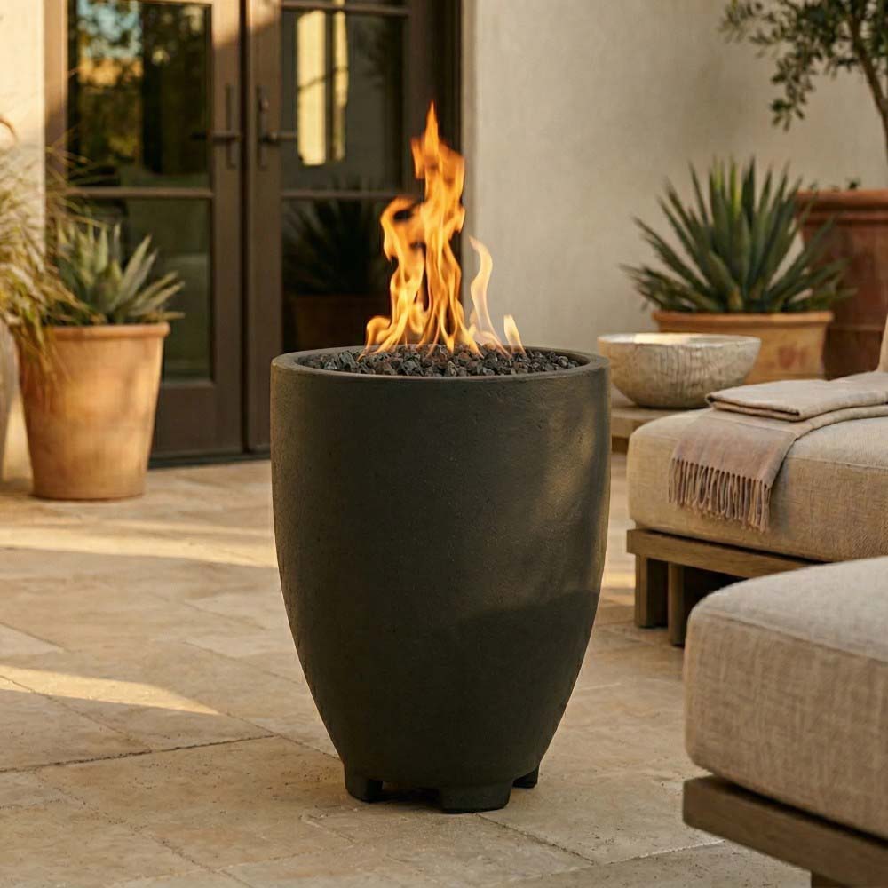 Dark concrete gas fire pit with open flame on patio, four leveling feet