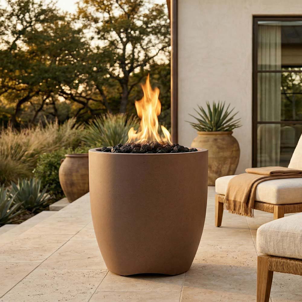 Concrete gas fire pit with flames, beige bowl near outdoor seating