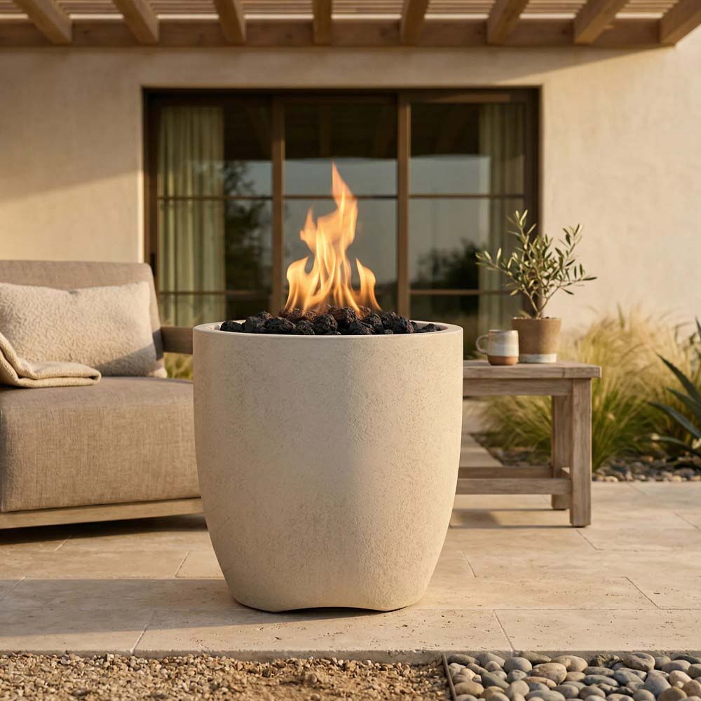Concrete gas fire pit with flames, light beige bowl outdoors