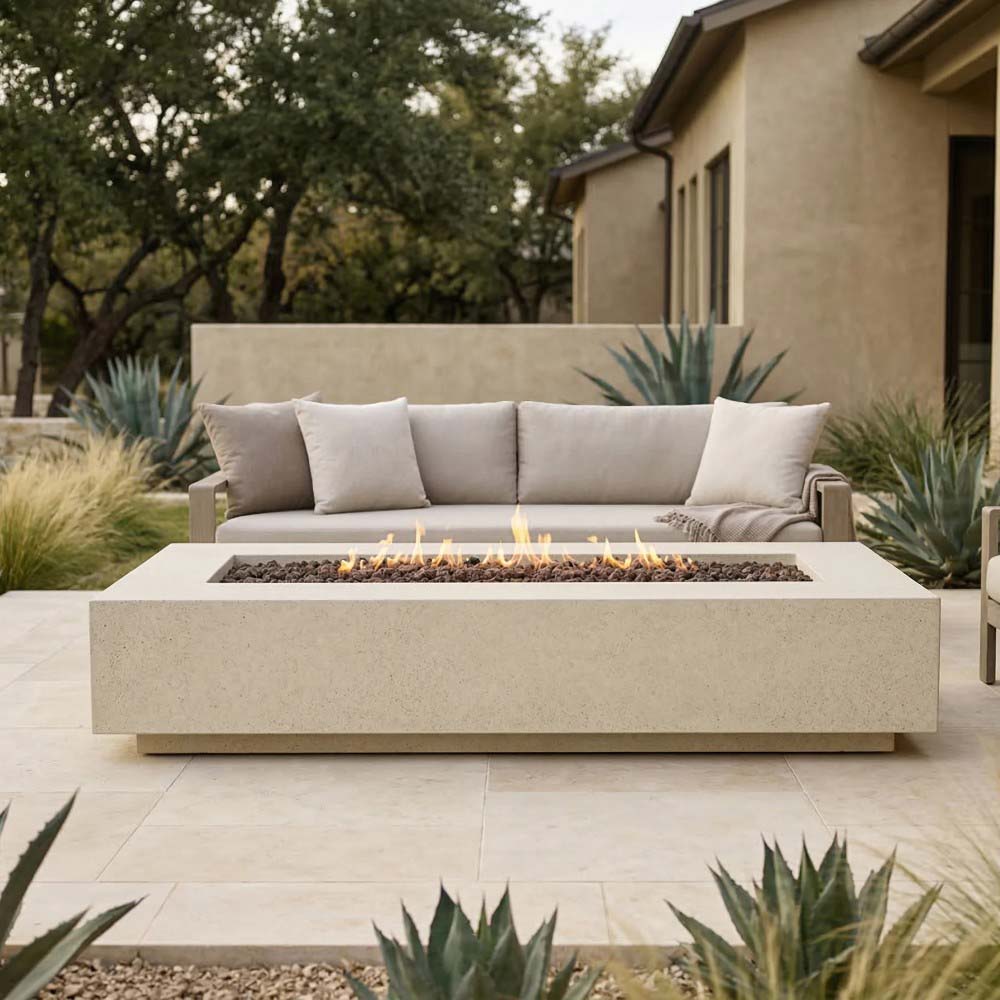 Rectangular concrete gas fire pit in light beige with flames over black fire media