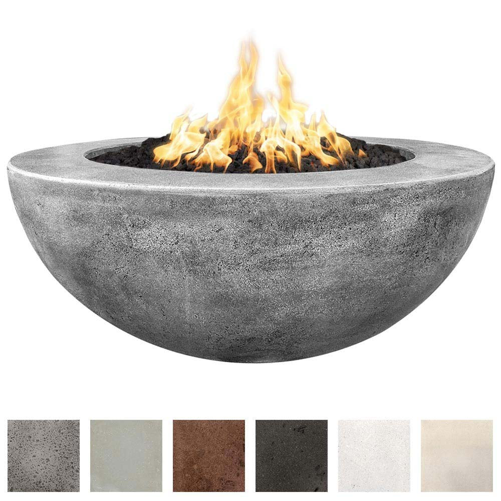 Gray concrete round gas fire pit with glowing flames and black lava rocks inside
