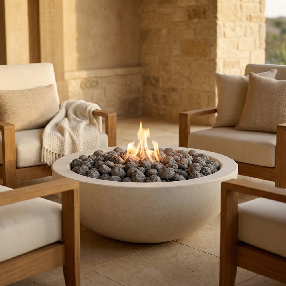 Light beige concrete round gas fire pit with flames and dark lava rocks