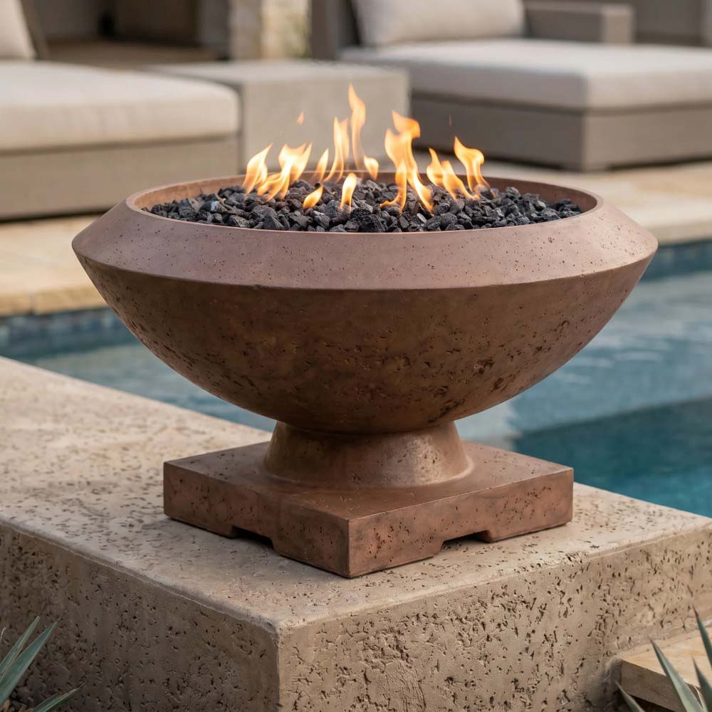 Concrete gas fire bowl with glowing flames and black lava rock inside