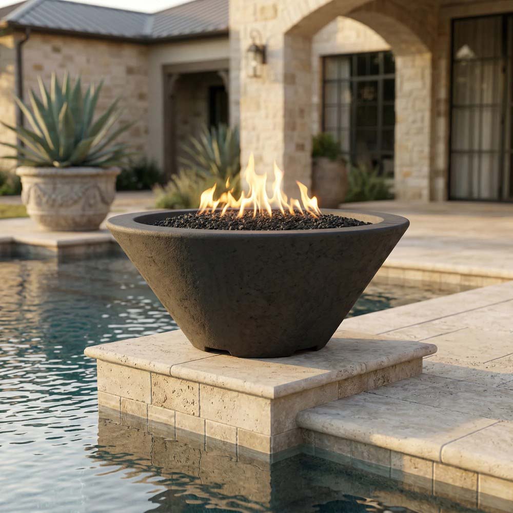 Tan concrete gas fire bowl with open flame and black lava rock on raised stone base