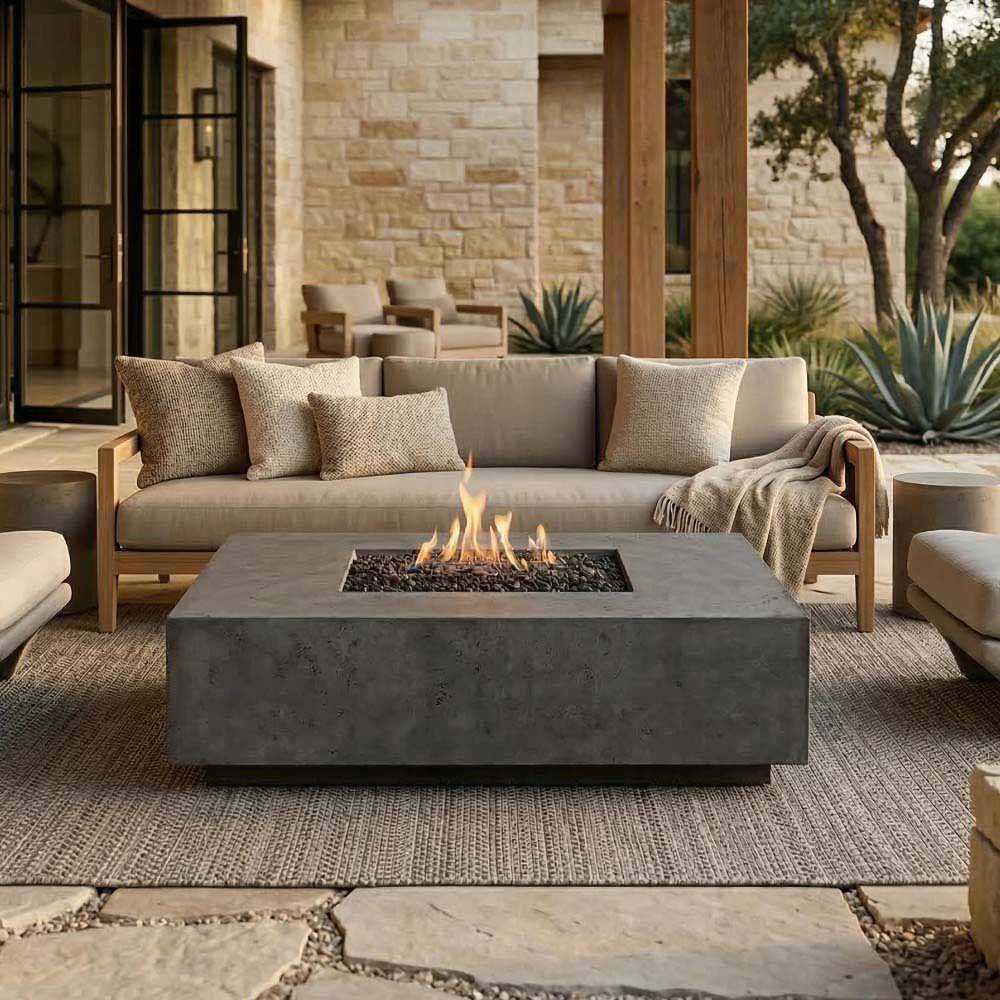 Rectangular concrete gas fire pit with flames in the inset burner center