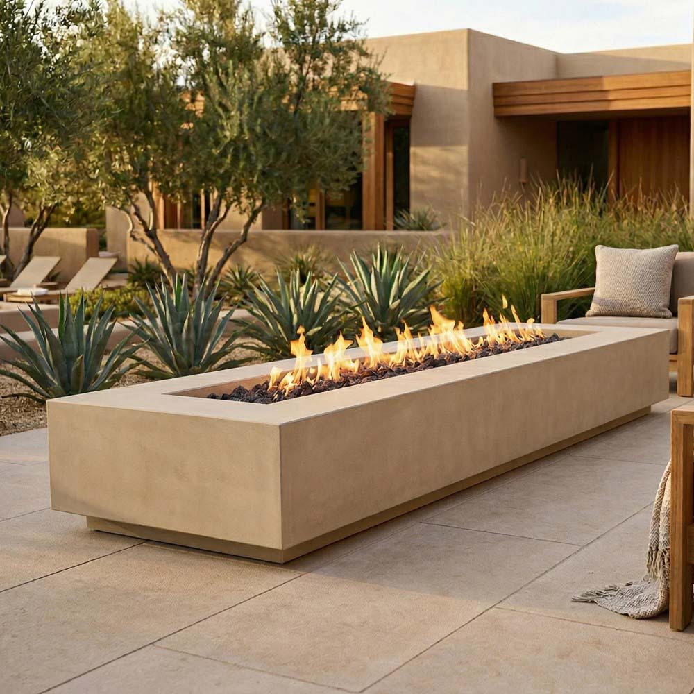 Light tan concrete gas fire pit with flames and tumbled lava rock bed