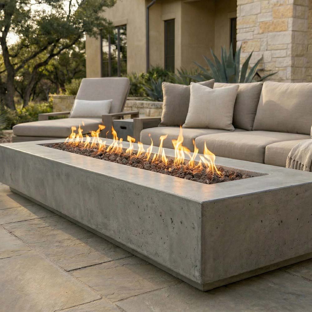 Concrete gas fire pit with flames, rectangular firebox and lava rock bed
