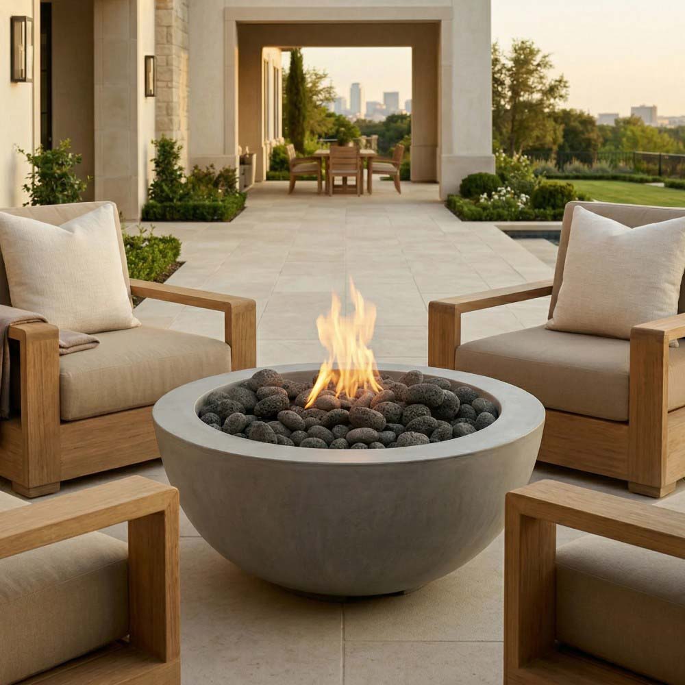 Modern concrete gas fire pit bowl with flame and dark lava rocks, patio centerpiece