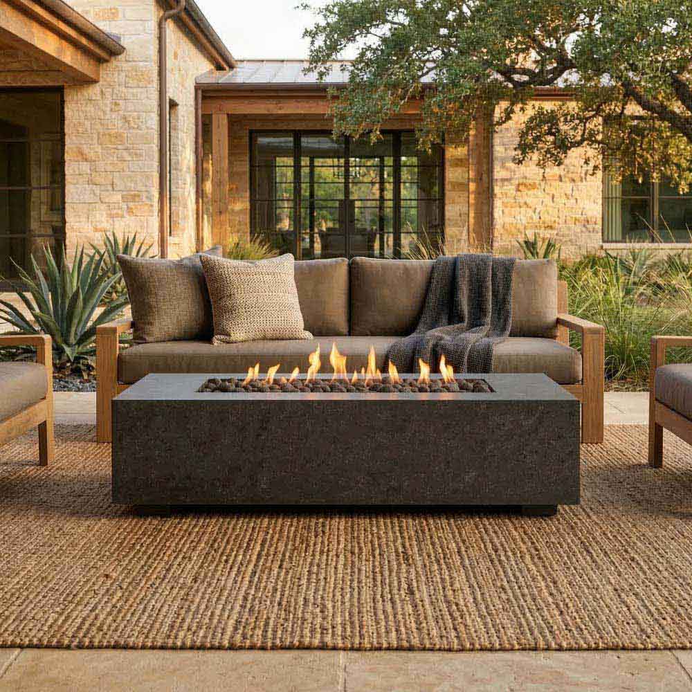 Low rectangular concrete gas fire pit with flames in the center, front view