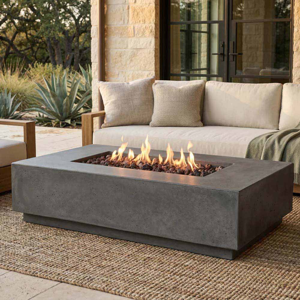 Gray concrete gas fire pit with steady flames in a rectangular bowl.