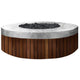 Round concrete gas fire pit with speckled gray top and dark lava rock center