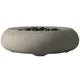 Concrete gas fire bowl with smooth oval rim and dark lava rocks, light gray finish.