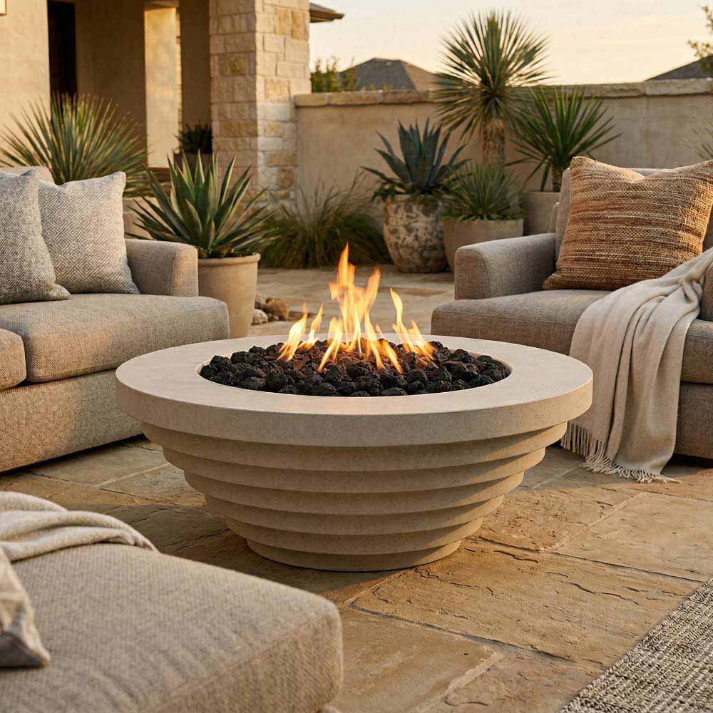 Outdoor patio round concrete gas fire pit with flames, surrounded by lounge seating