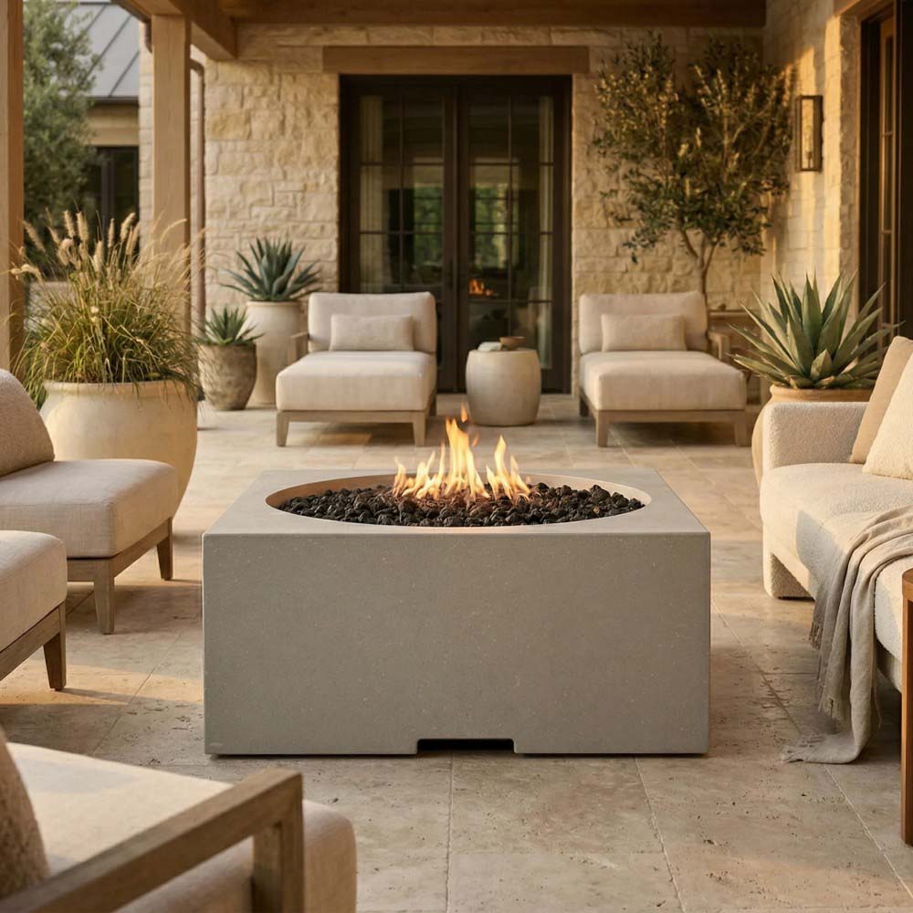 Rectangular gray concrete gas fire pit with visible flames in outdoor seating area
