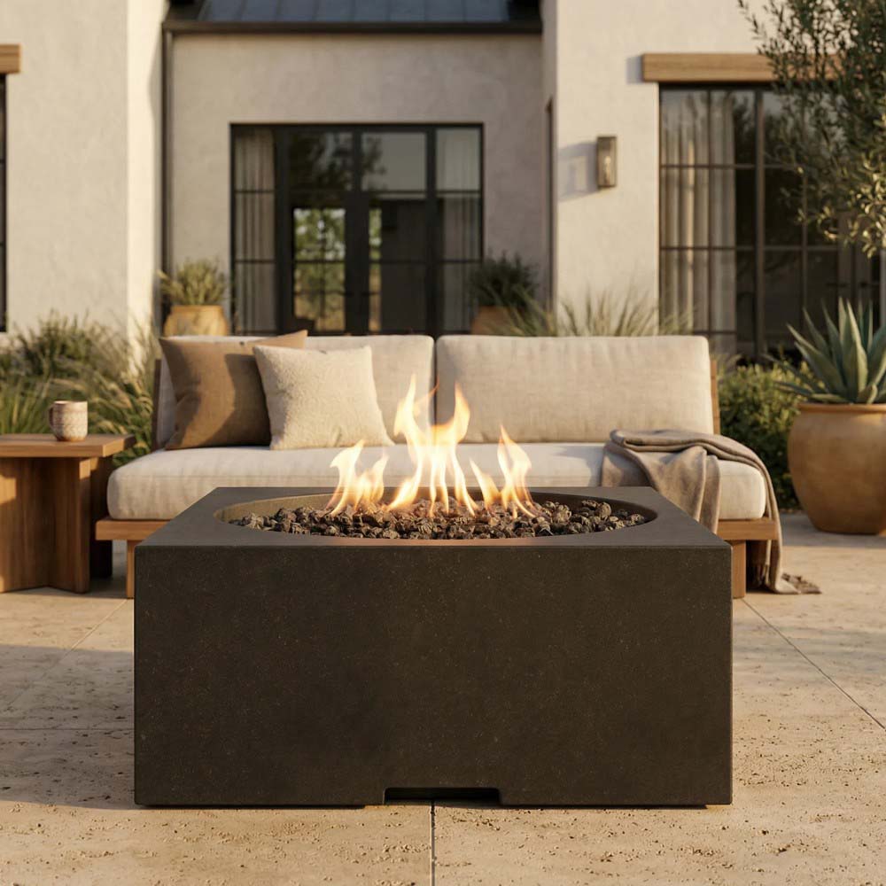 Dark brown/black square concrete gas fire pit with flames in patio setting