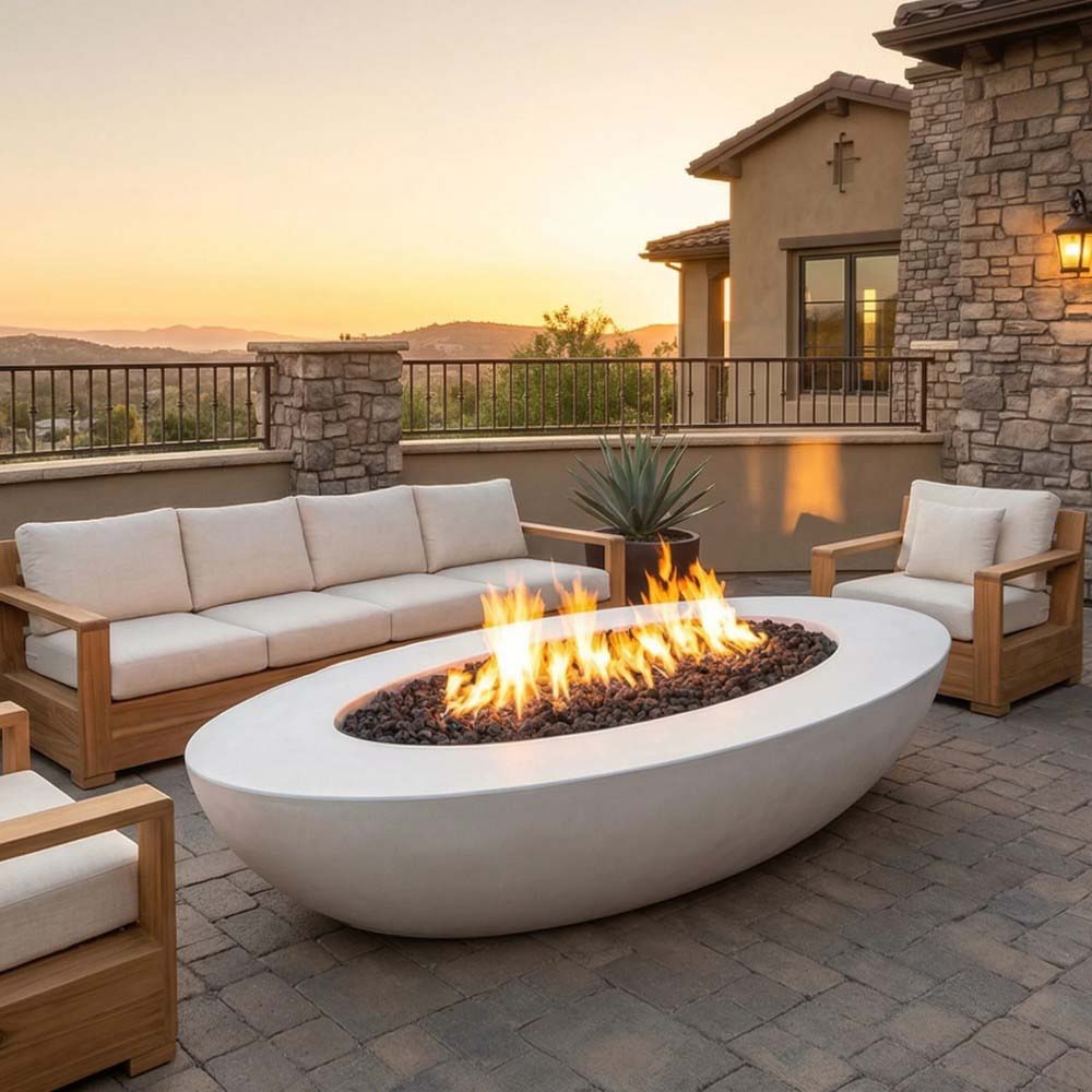 White oval concrete gas fire pit with flames and black lava rocks