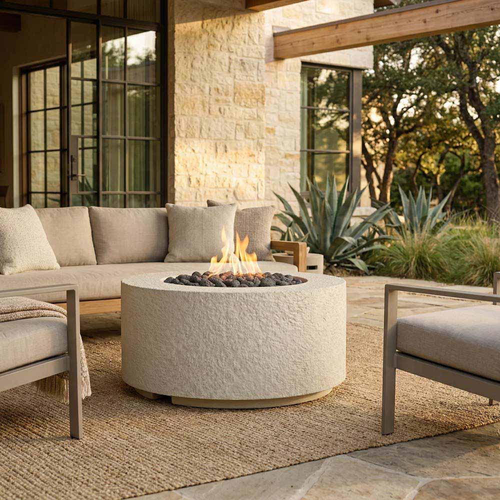 Cylindrical stone-textured concrete gas fire pit with flame and lava rock insert