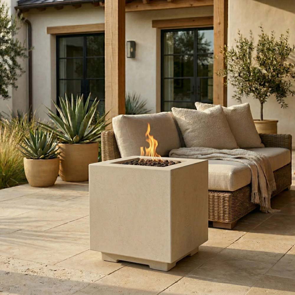 Square concrete gas fire pit with burning flames in a light natural finish