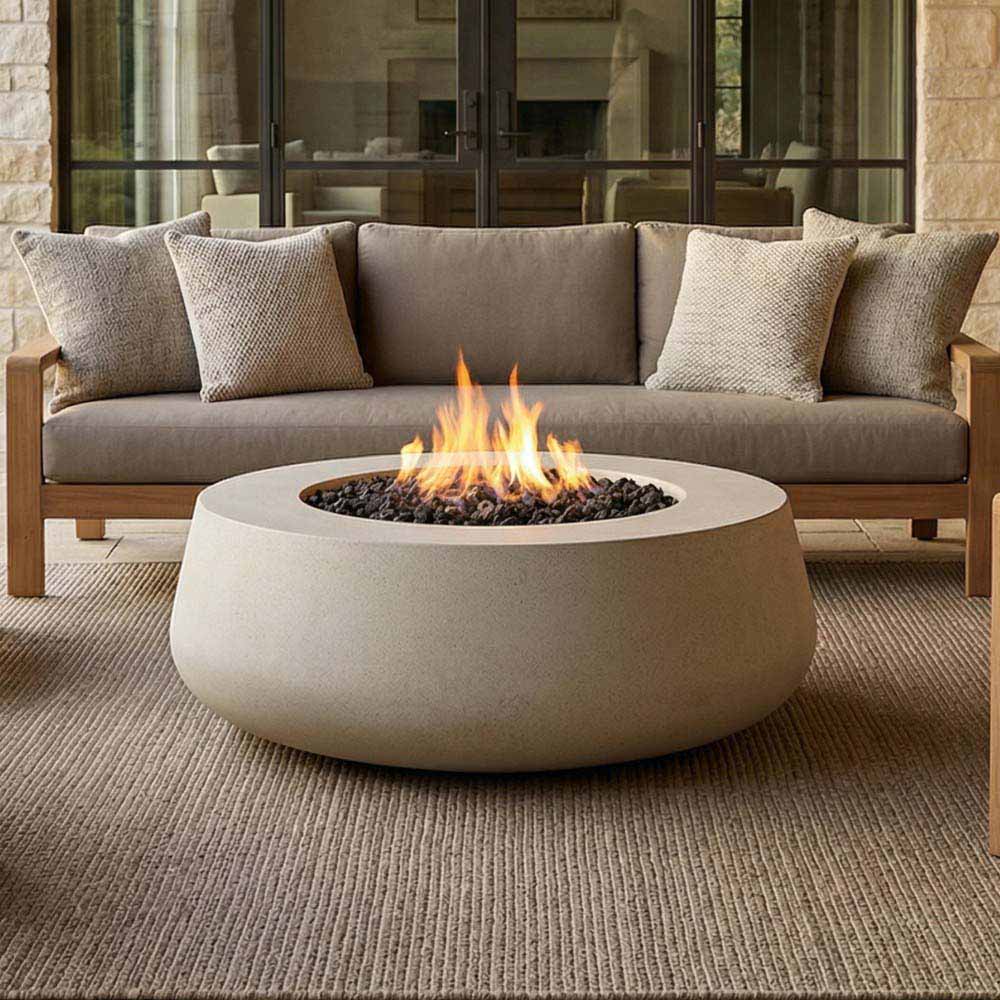 Light gray concrete gas fire bowl with visible flames in the center