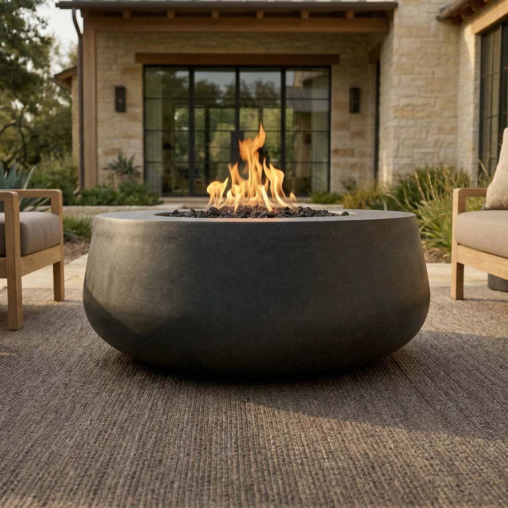 Charcoal concrete gas fire bowl with flames rising from the burner