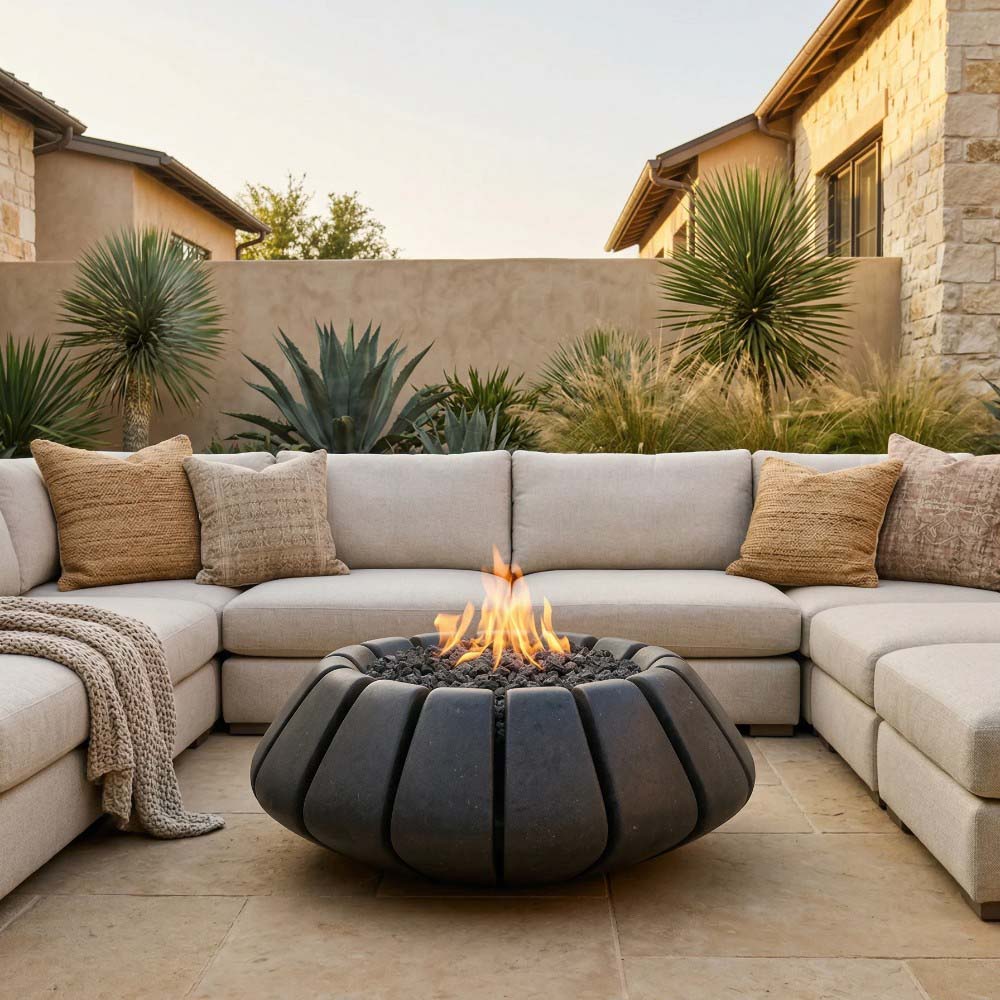 Dark gray concrete gas fire bowl with ribbed shell and visible center flames