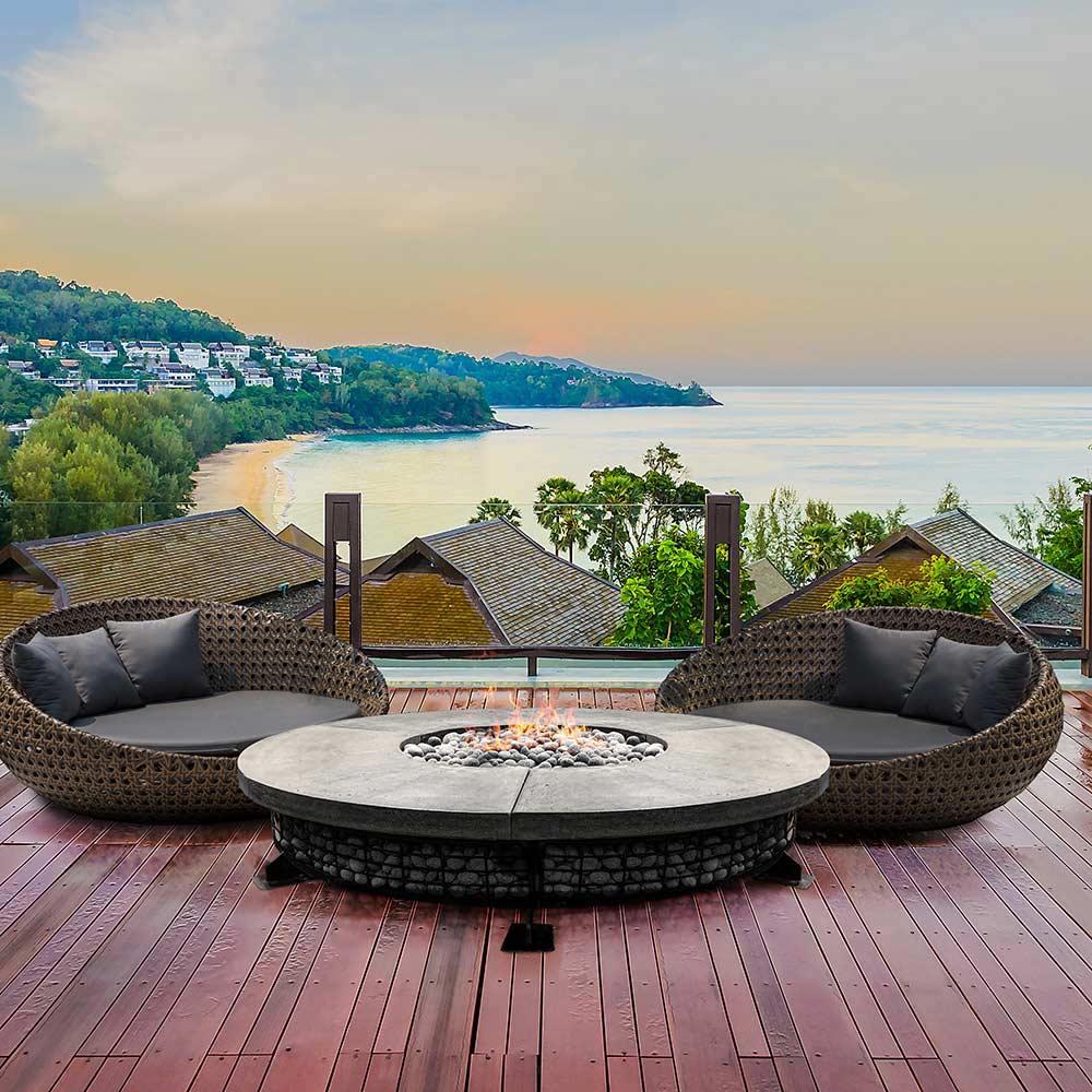 Round concrete gas fire pit with stone-filled burner and seating arrangement around it