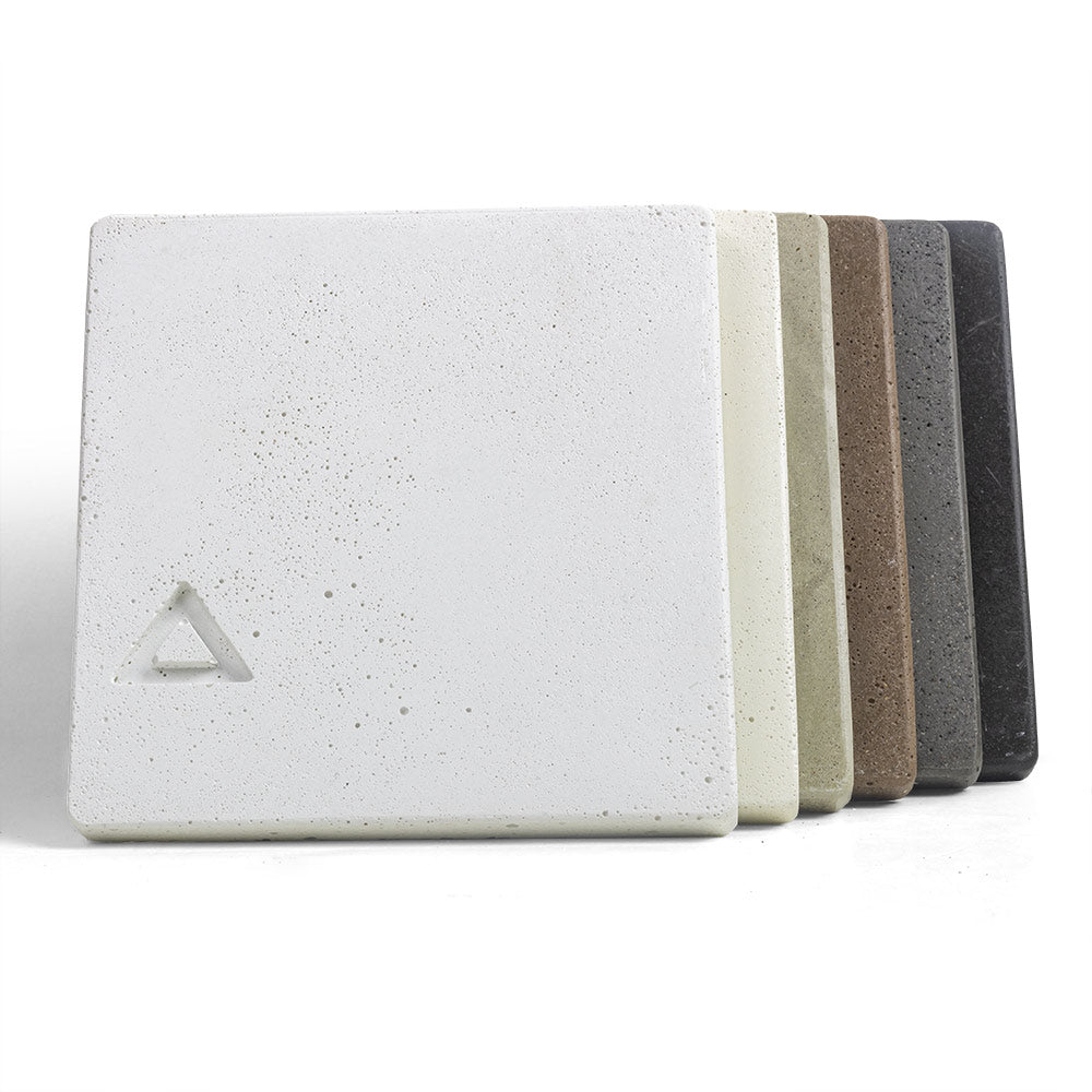 Concrete chip sample stack, off-white squares and striped layers in cream, tan, and dark gray.