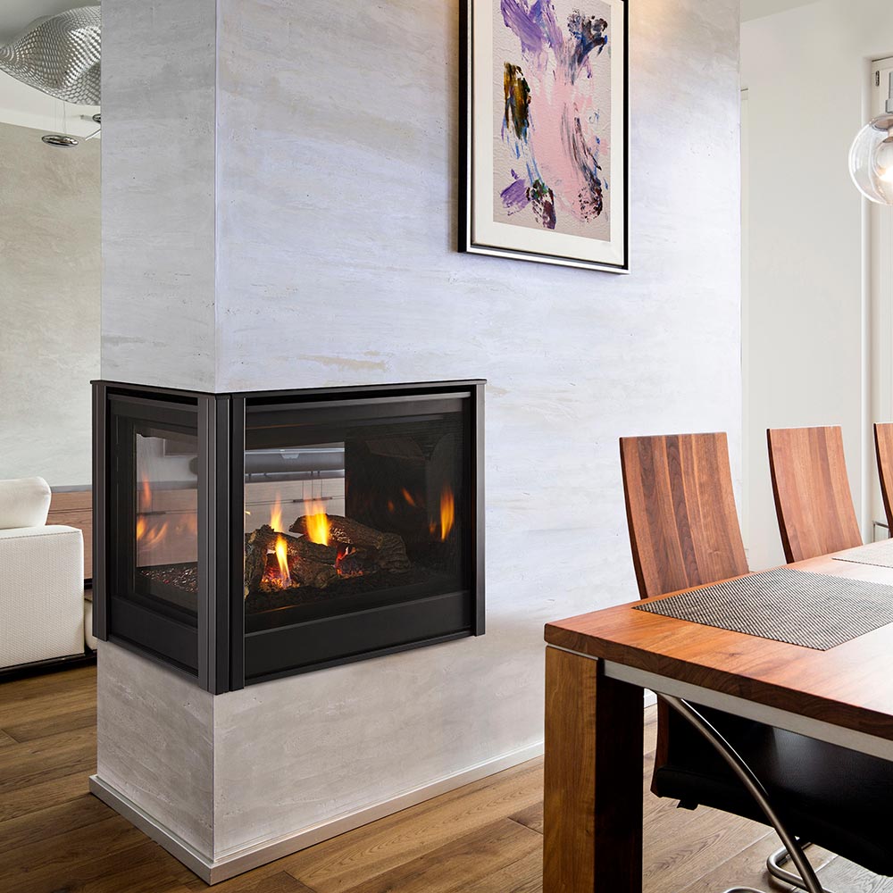 Black multi-sided direct vent gas fireplace built into a wall with flames visible