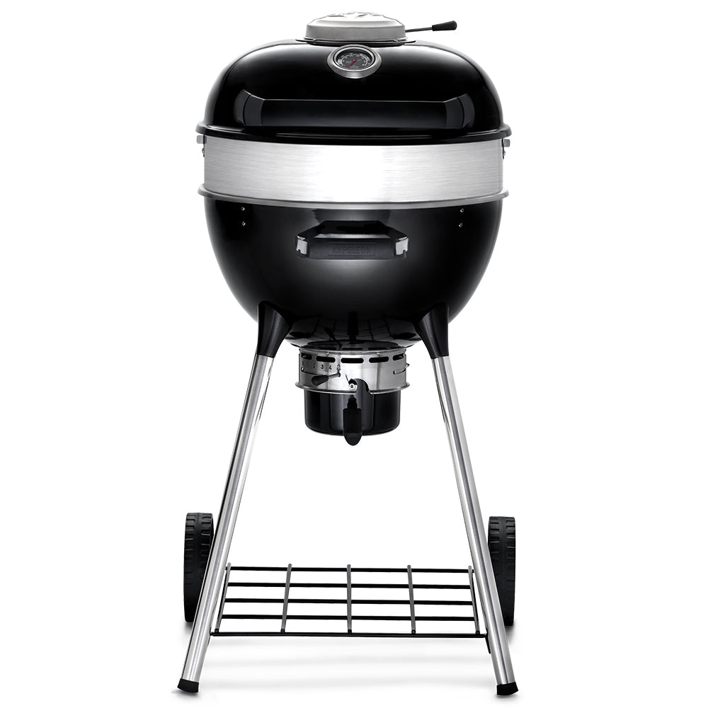Charcoal kettle grill with black dome lid, silver rim, and chrome tripod legs