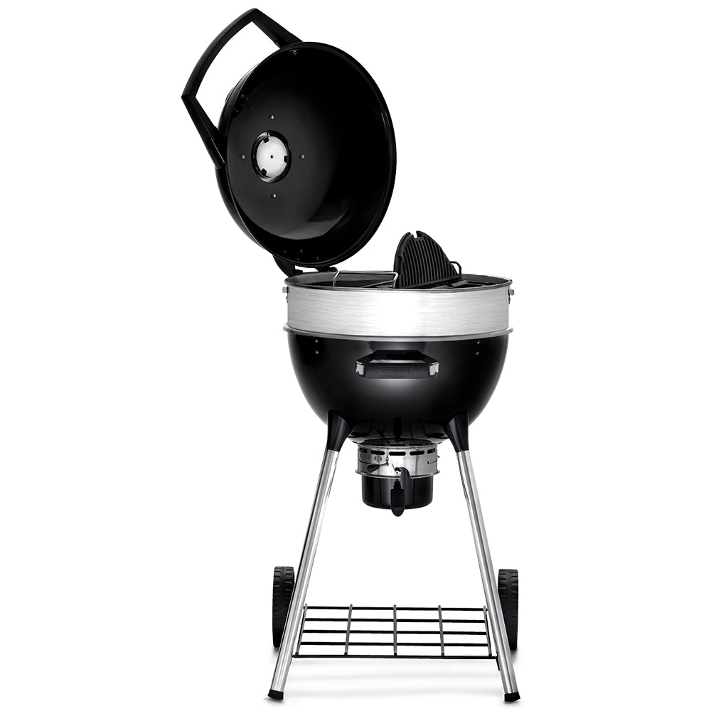 Charcoal kettle grill with lid open, black firebox, and chrome tripod legs