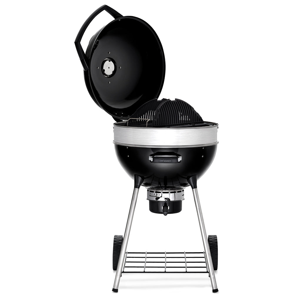 Black charcoal kettle grill with lid open, firebox, and lower cooking grate visible