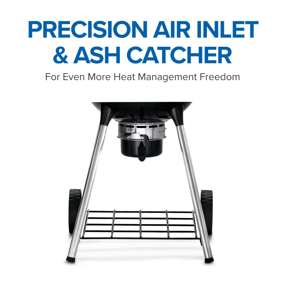 Black charcoal kettle grill with open lid, grate, and ash-catcher area below
