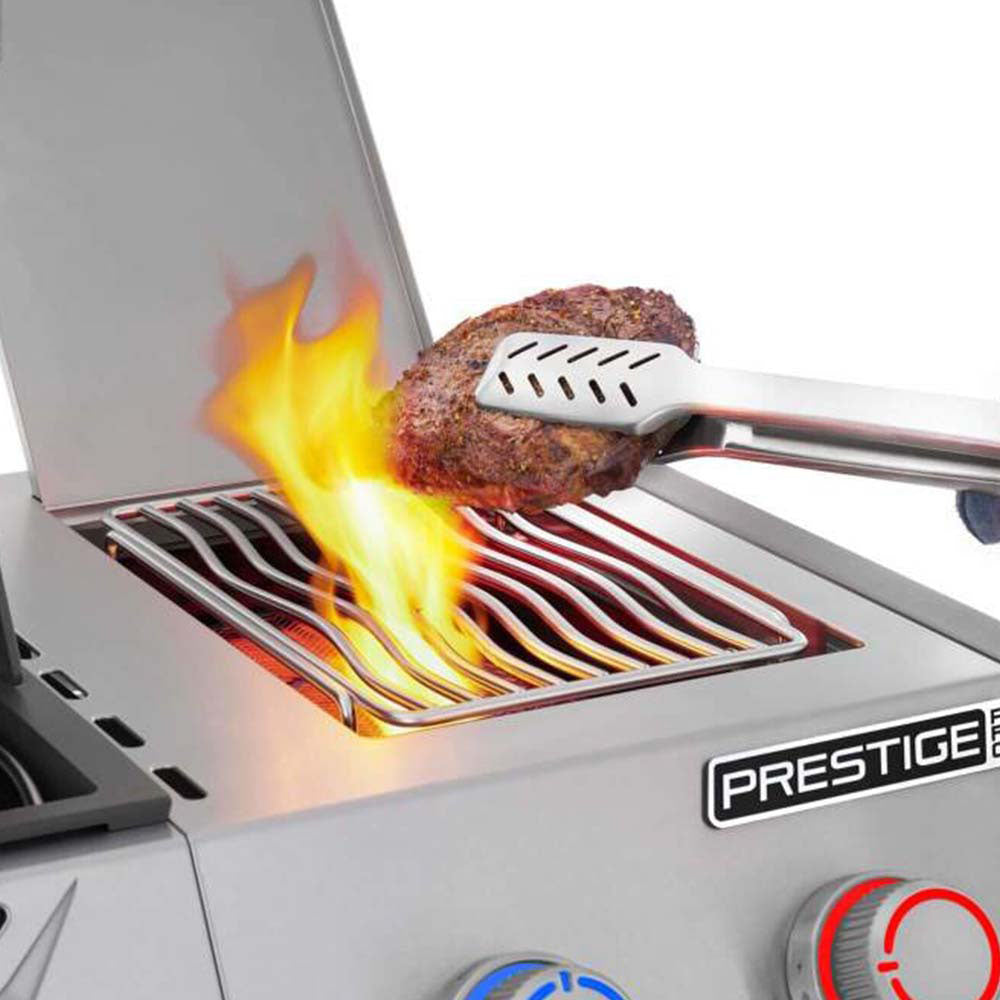 Gas grill burner flare-up above stainless steel cooking grates