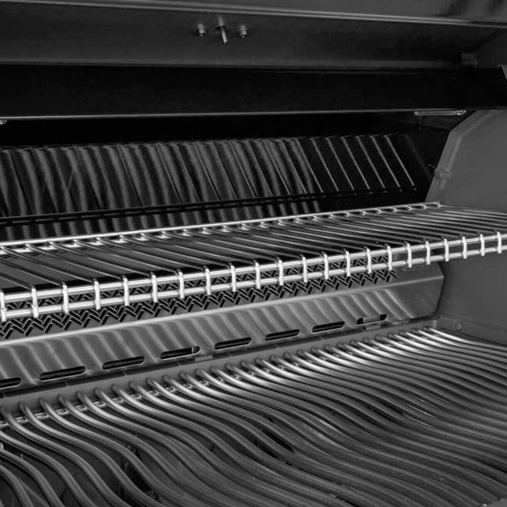 Close-up of stainless steel cooking grates and heat channels inside the grill