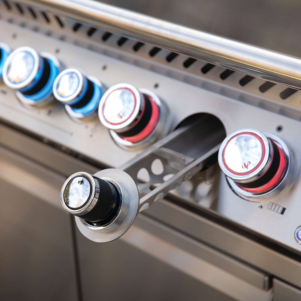 Close-up of stainless gas grill control knobs with blue and red accent rings