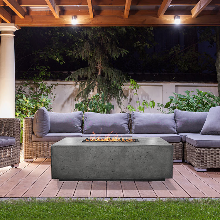Concrete gas fire pit with burner tray, rectangular gray body on outdoor patio