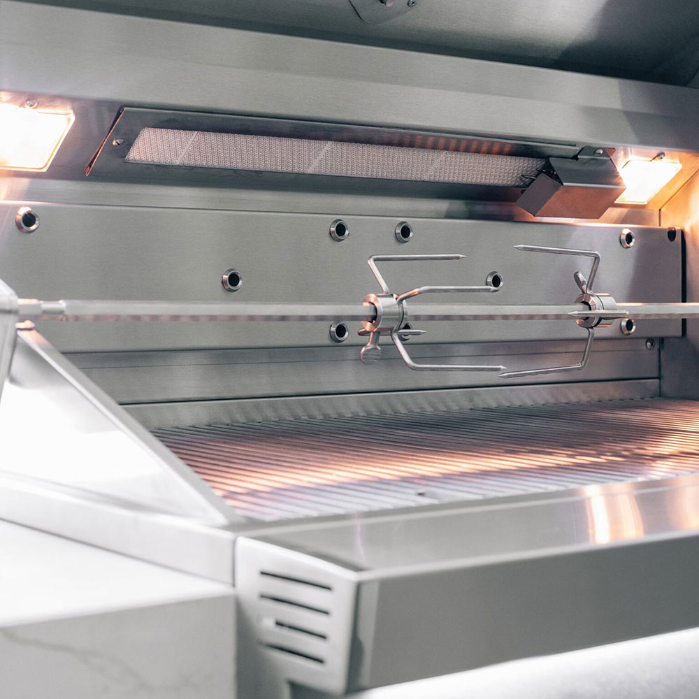 Built-in gas grill open hood with burners and control area visible.