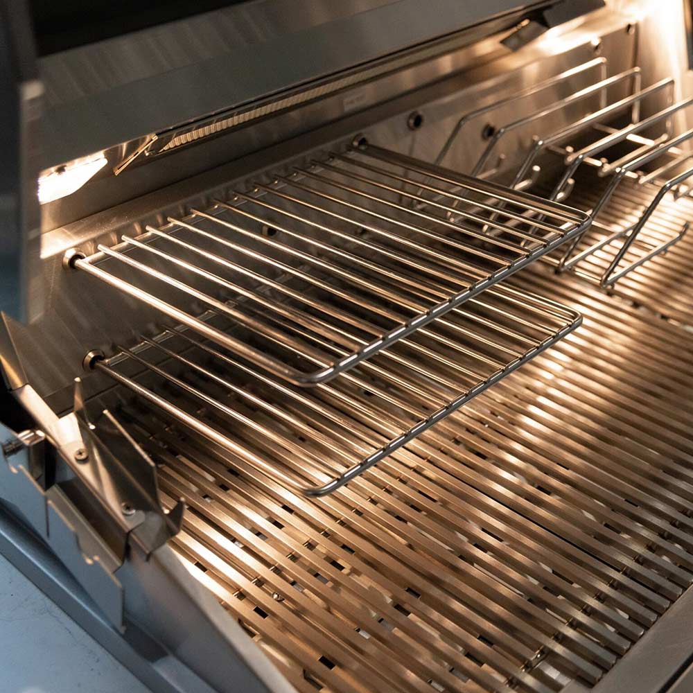Stainless steel grill cooking grates above glowing burner heat