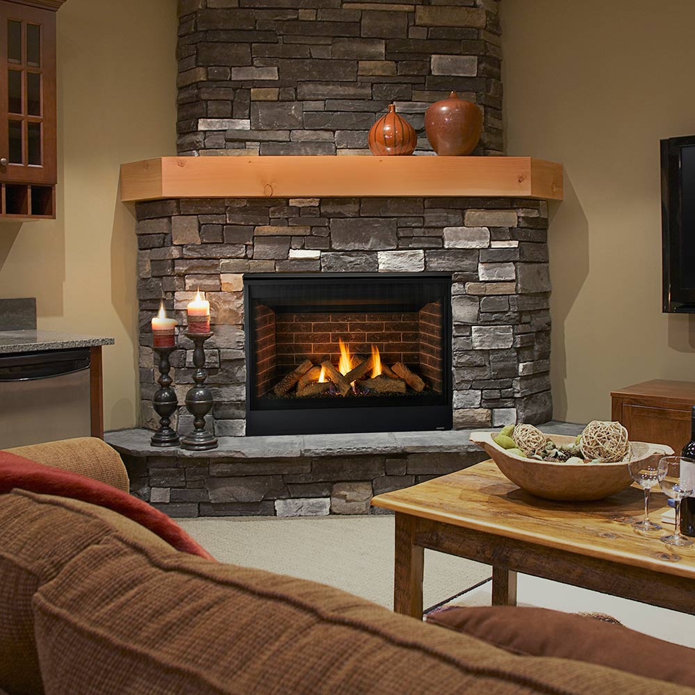 Stone-surround direct-vent gas fireplace with black firebox and visible flames
