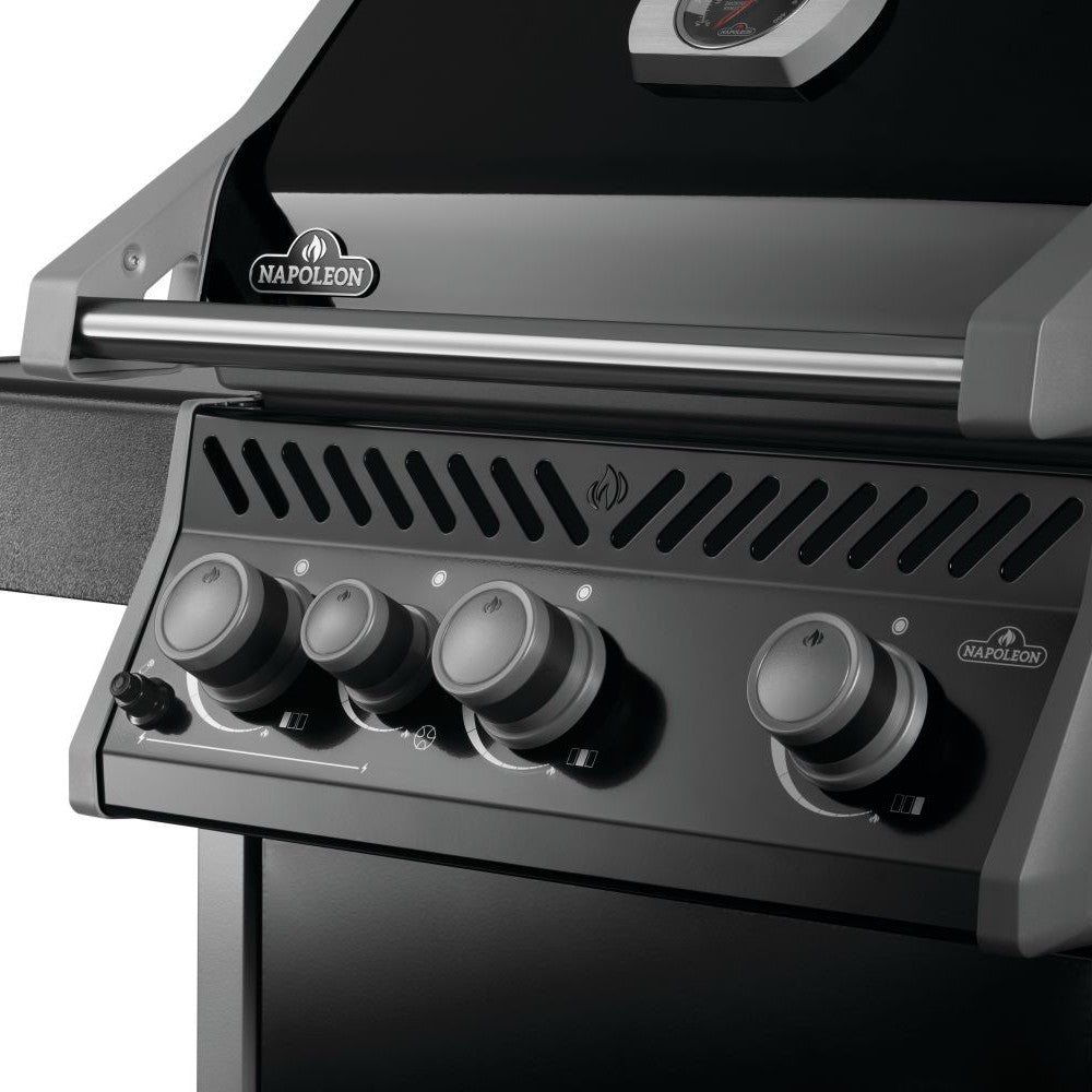 Black gas grill control panel with four round knobs and ignition controls