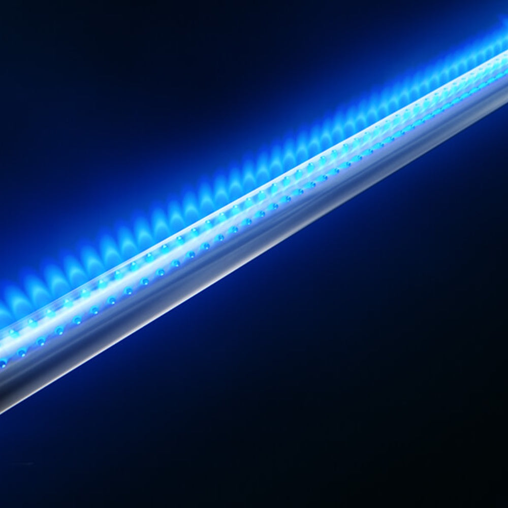 Blue-lit grill burner tube bar under the cooking hood