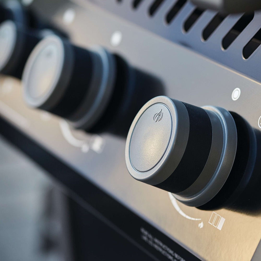 Gas grill control knob with ignition icon on black control panel
