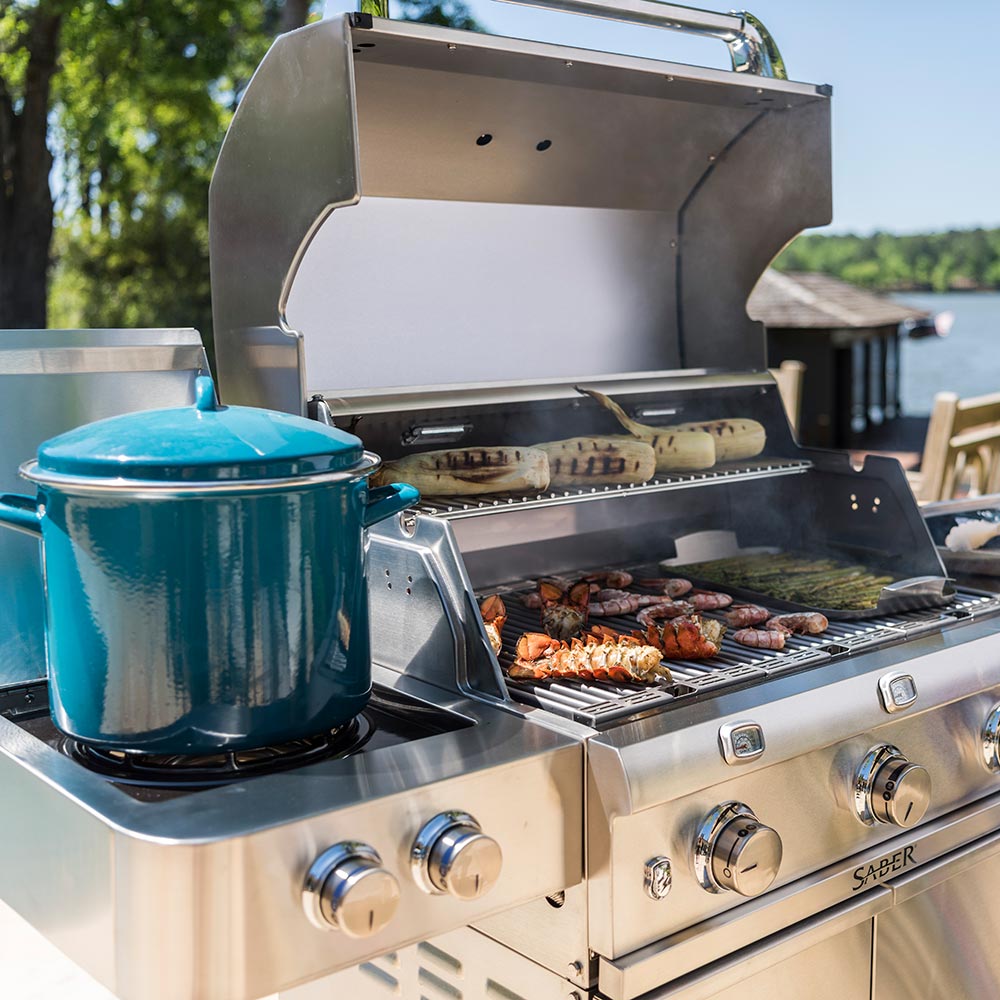 Infrared grill with side burner kettle and cooking grates under open lid