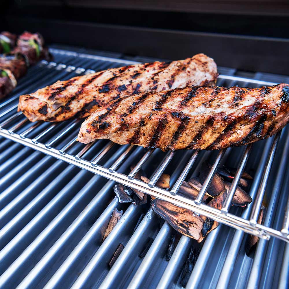 Grilled meat on stainless steel infrared grill grates