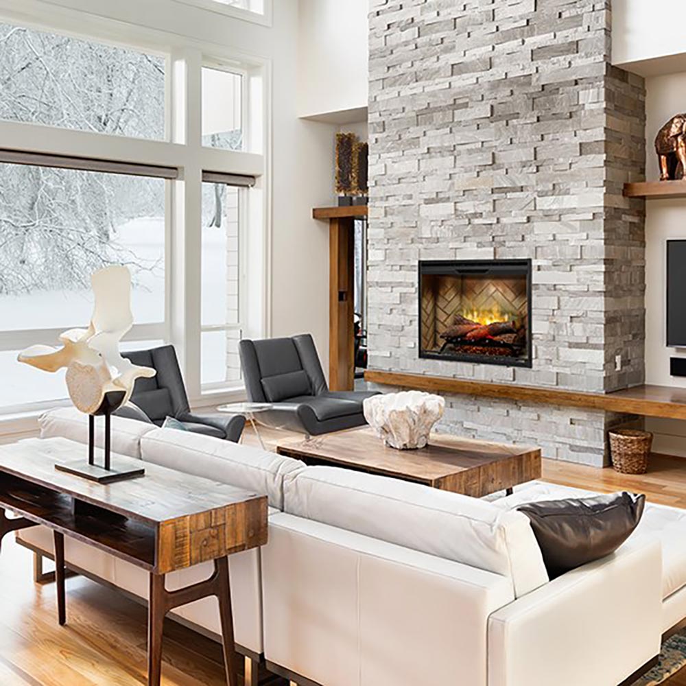 Electric fireplace insert with glass front showing faux flame and log bed in mantel