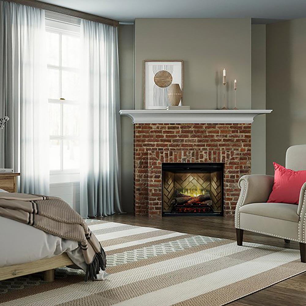 Electric fireplace with glass front and faux flame behind logs in brick surround