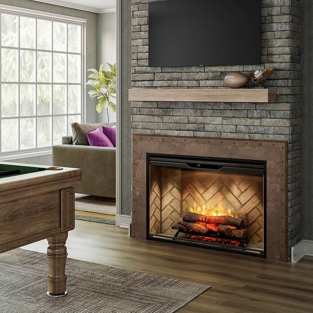 Electric fireplace insert with glass viewing window, glowing log-style flame effect, and stone surround