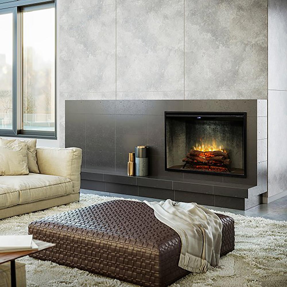 Electric fireplace insert with black frame and glass front, burning logs behind glass
