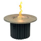 Round gas fire pit table with light wood top and dark fluted base; flames in center.