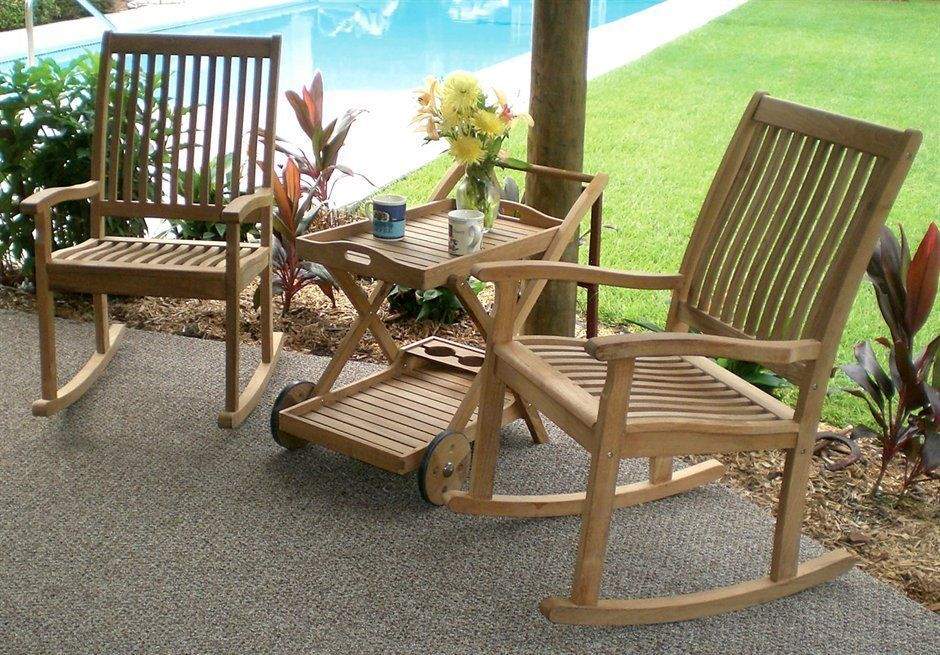Set of wooden rocking chairs with slatted high backs and seats, curved base runners.